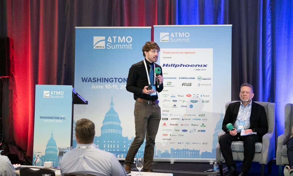 Robbie Svidron of Intellihot presenting the company's tankless CO2 heat pump hot water heaters at ATMO America 2024.